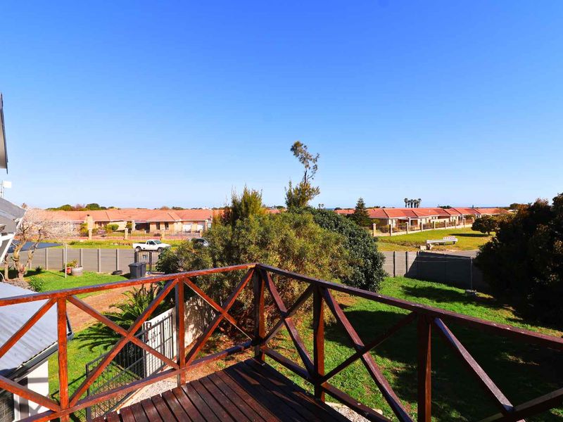 Elevated wooden balcony overlooking the rear garden and surrounding residential neighborhood.