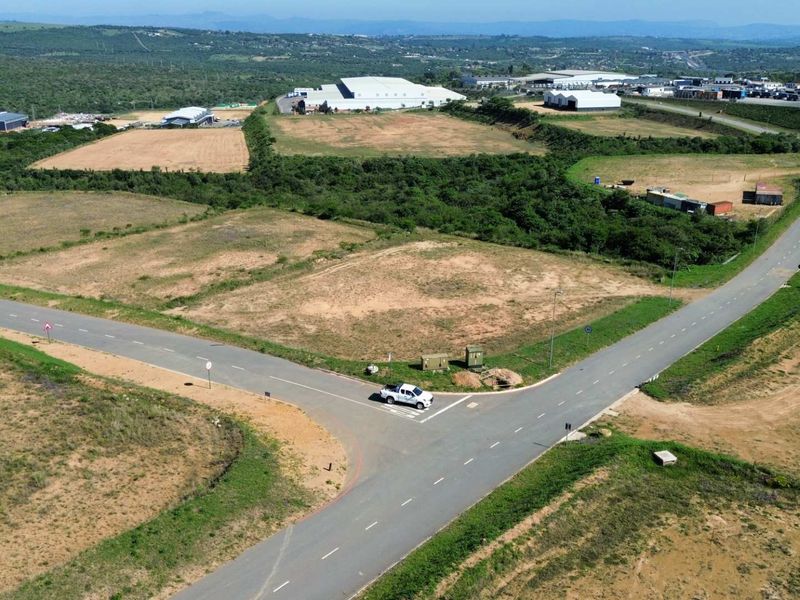 Aerial view of a developed industrial land parcel featuring established asphalt road infrastructure and utility access points within a larger industrial estate.