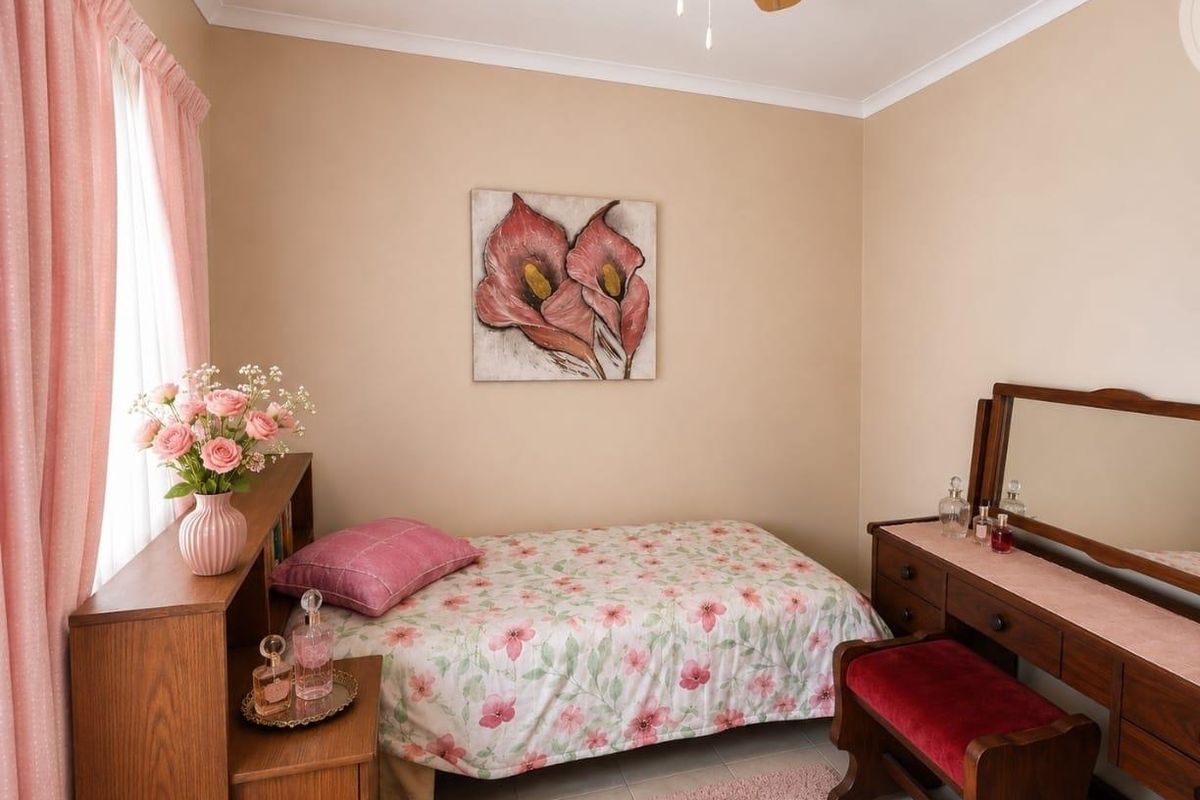 A well-maintained bedroom featuring neutral wall tones, tiled flooring, and a ceiling fan, offering a comfortable and functional living space.
