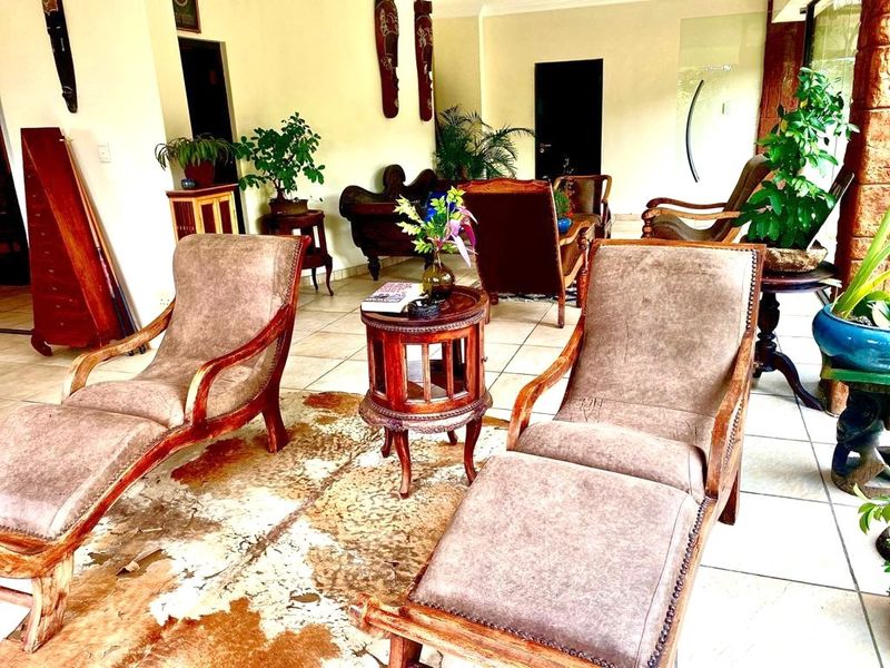 A spacious living area featuring neutral walls and tiled flooring, offering a versatile layout for comfortable seating and relaxation.