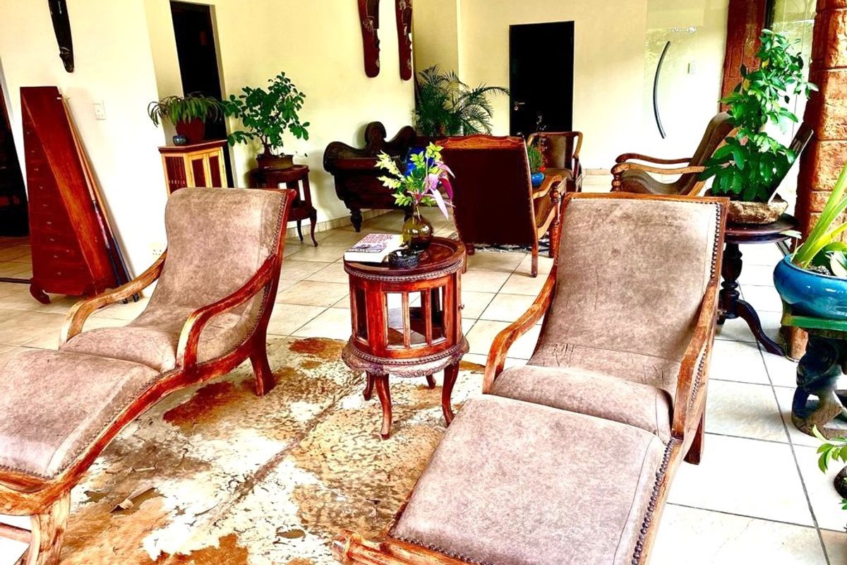 A spacious living area featuring neutral walls and tiled flooring, offering a versatile layout for comfortable seating and relaxation.