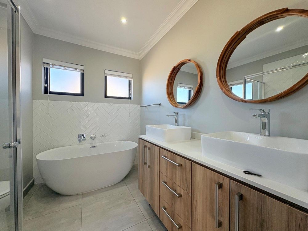 Spacious, modern bathroom with bath and shower.