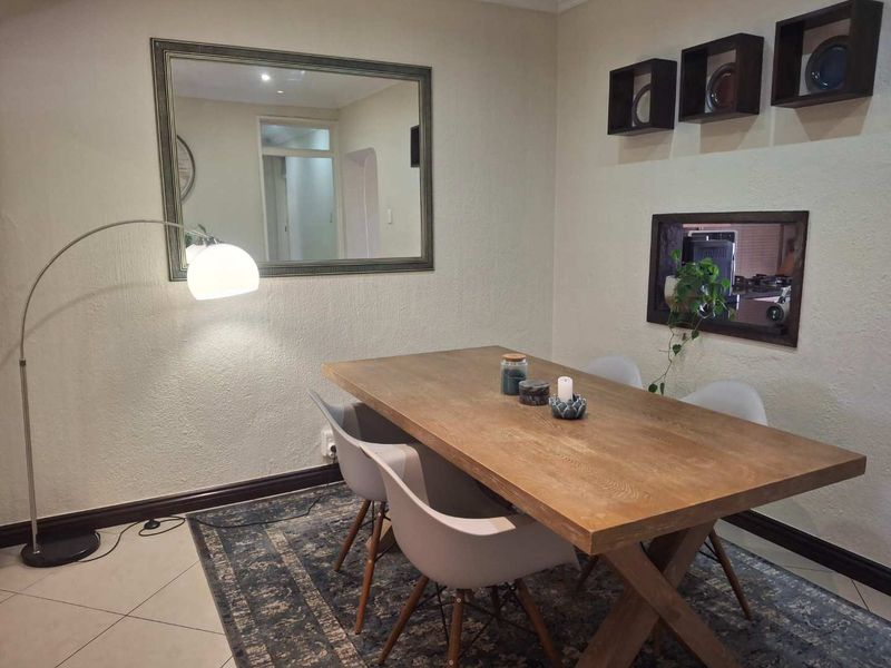 A well-maintained dining area featuring tiled flooring and neutral wall finishes, providing a functional space for meals.
