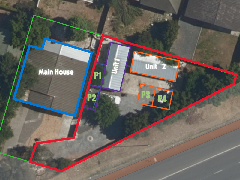 An aerial view of the property layout, highlighting the main house, two additional units, and designated parking areas within the fenced boundary.