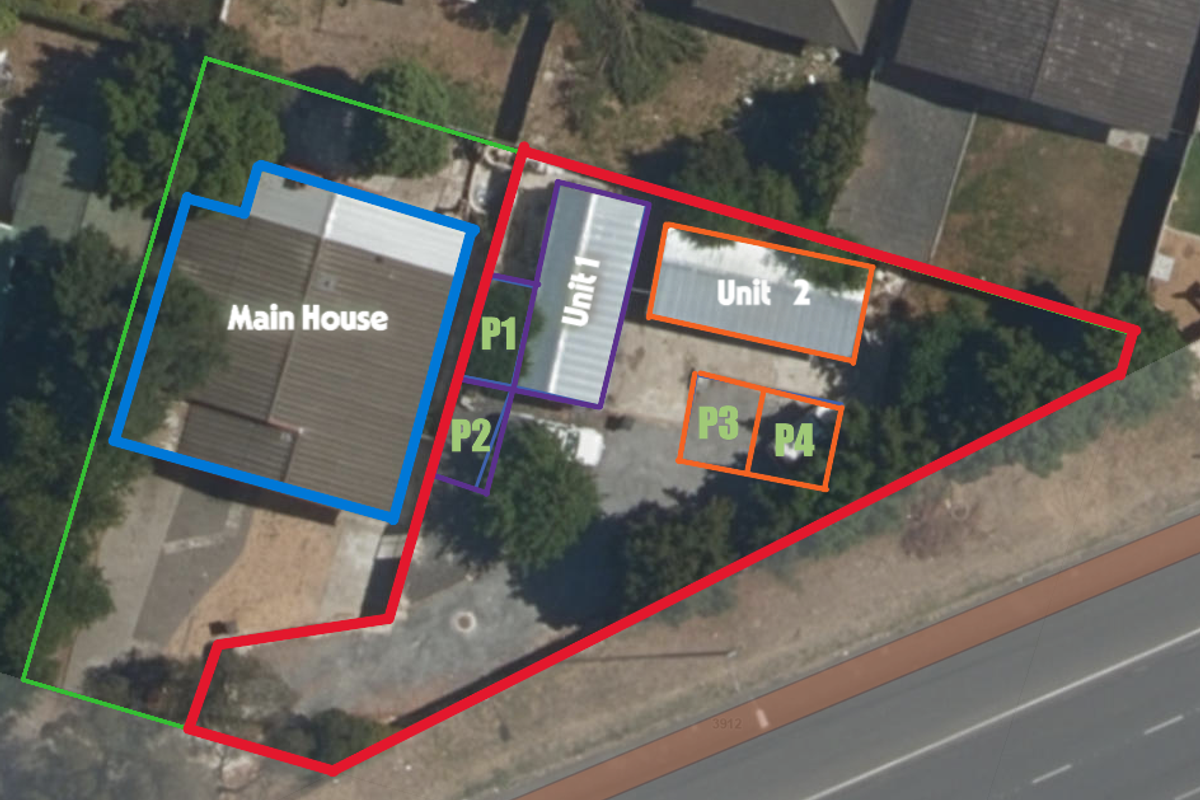 An aerial view of the property layout, highlighting the main house, two additional units, and designated parking areas within the fenced boundary.