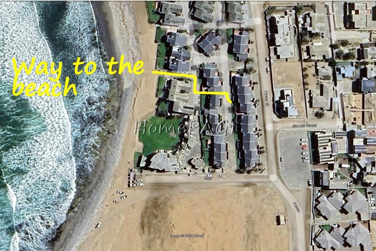 Aerial view of the townhouse complex showing its proximity to the beach and surrounding street layout.
