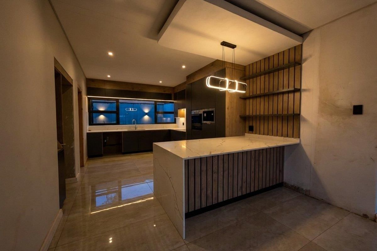 Modern kitchen featuring a large island with quartz countertops, slatted wood accents, built-in appliances, and sleek dark cabinetry in a contemporary open-plan layout.