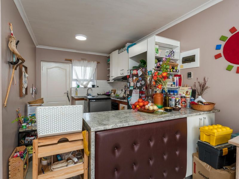 Compact kitchen featuring laminate countertops, built-in cabinetry, and a functional sink area, offering a practical layout for daily meal preparation.