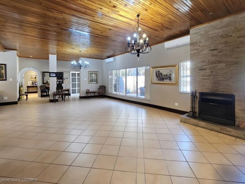 Spacious living area featuring a timber-clad ceiling, stone-clad fireplace, ceramic floor tiles, and split-system air conditioning.