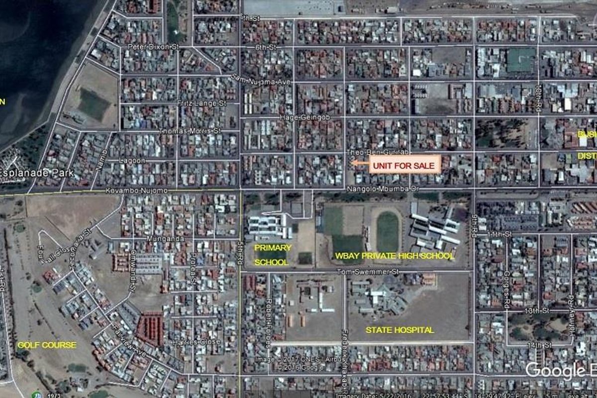 An aerial satellite view showing the property location in relation to local schools, the hospital, and the business district.