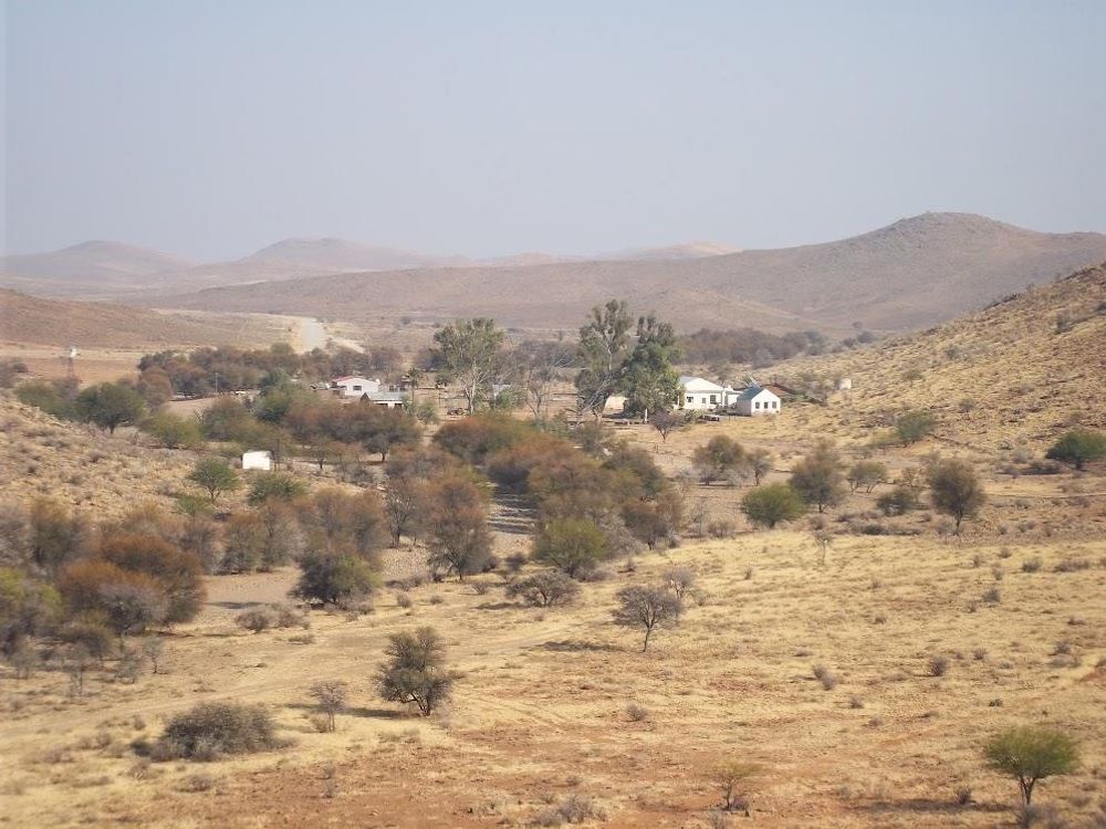 Farm houses as seen from afar and from a slight high point