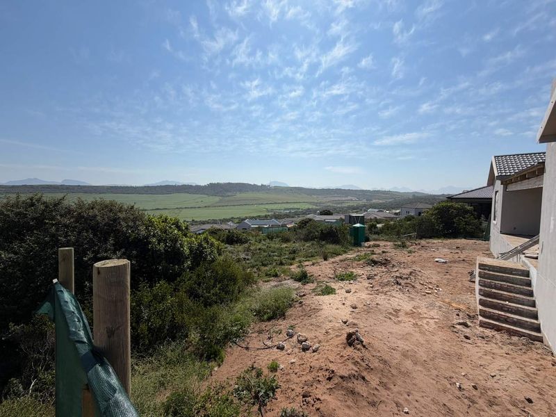 A view of the surrounding landscape and residential area from an unfinished residential property plot.