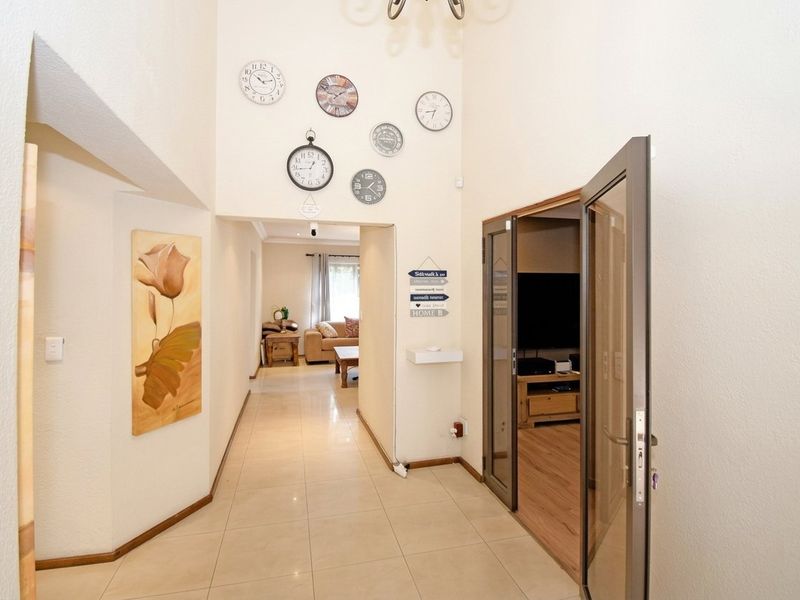 A bright entrance hall featuring high ceilings and tiled flooring, providing a clear transition into the living areas of the home.
