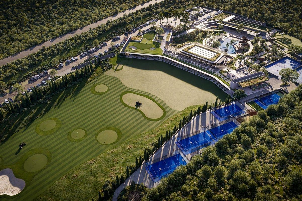 Aerial view of a luxury estate featuring a golf course, multiple tennis courts, a swimming pool, and extensive clubhouse facilities.