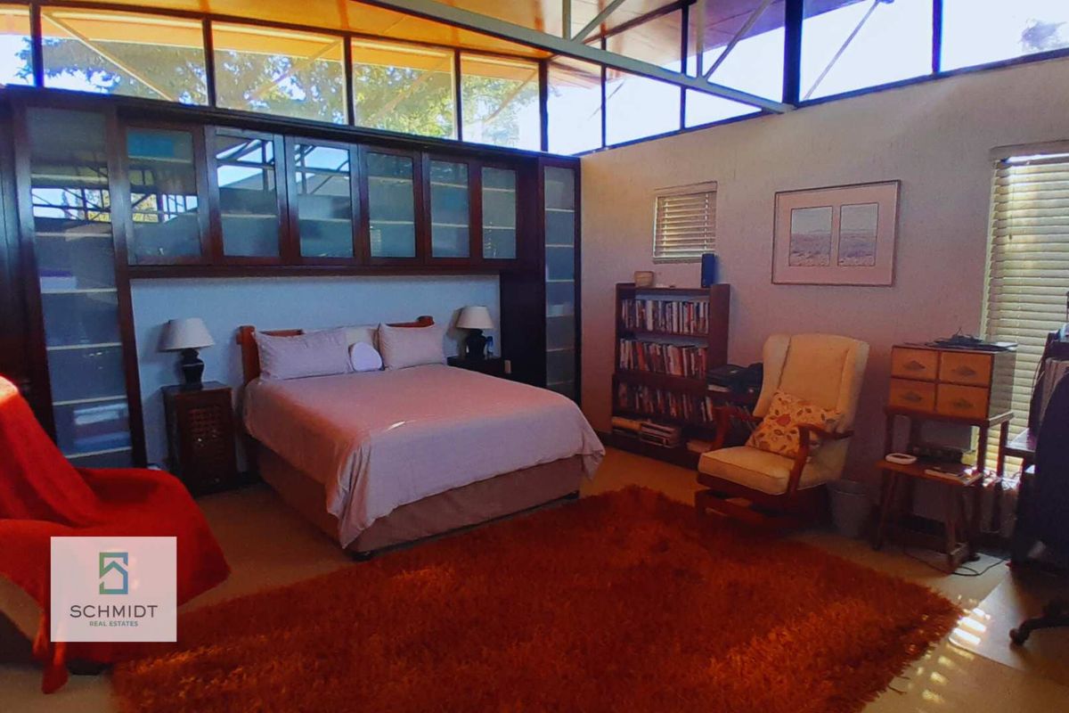 Spacious bedroom featuring extensive built-in cabinetry and high clerestory windows that provide ample natural light.