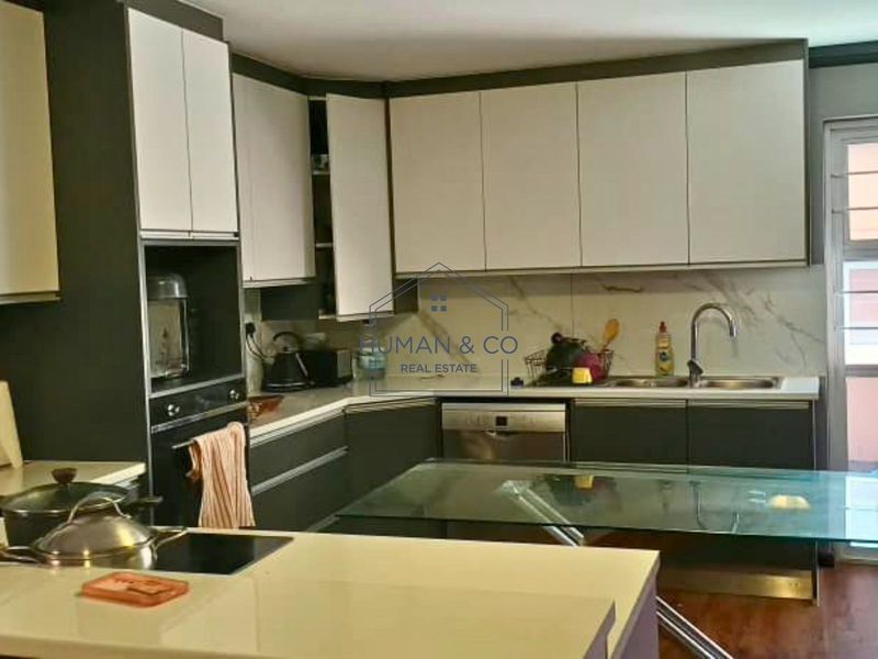 Modern kitchen featuring two-tone cabinetry, stone countertops, marble-look splashback, and integrated appliances including an oven and dishwasher.