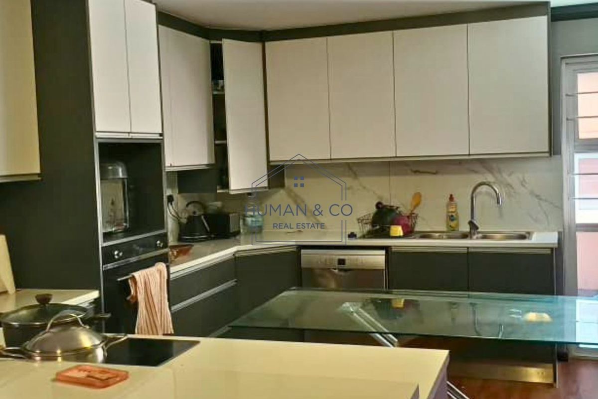 Modern kitchen featuring two-tone cabinetry, stone countertops, marble-look splashback, and integrated appliances including an oven and dishwasher.