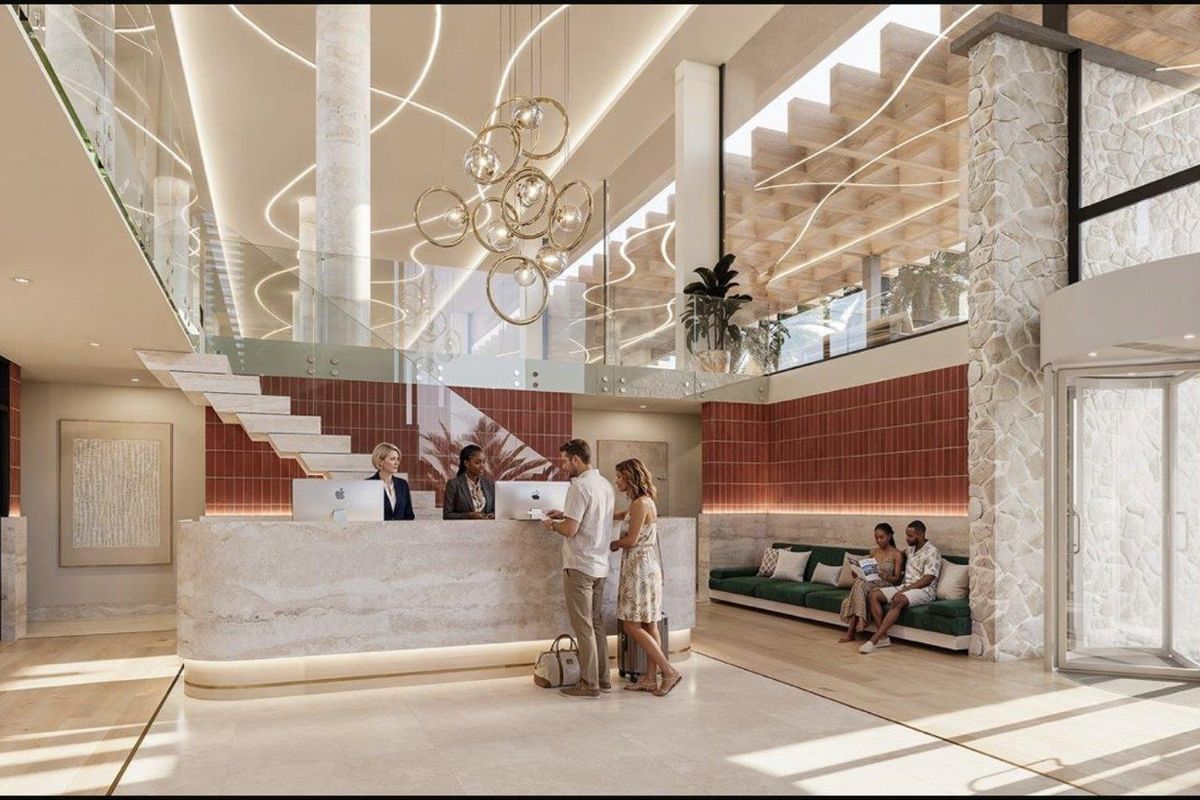 A modern, high-end apartment building lobby featuring a stone reception desk, terracotta tile accents, and a grand double-volume entrance with glass balustrades.
