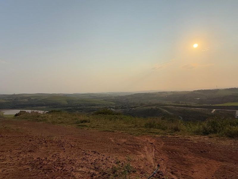 A scenic elevated view overlooking rolling hills and landscape, capturing the natural terrain of the vacant residential land.
