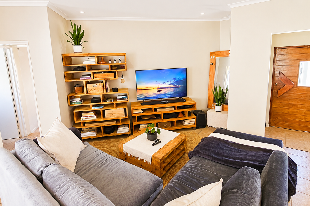 A comfortable living room featuring tiled flooring, recessed lighting, and a solid timber entrance door.