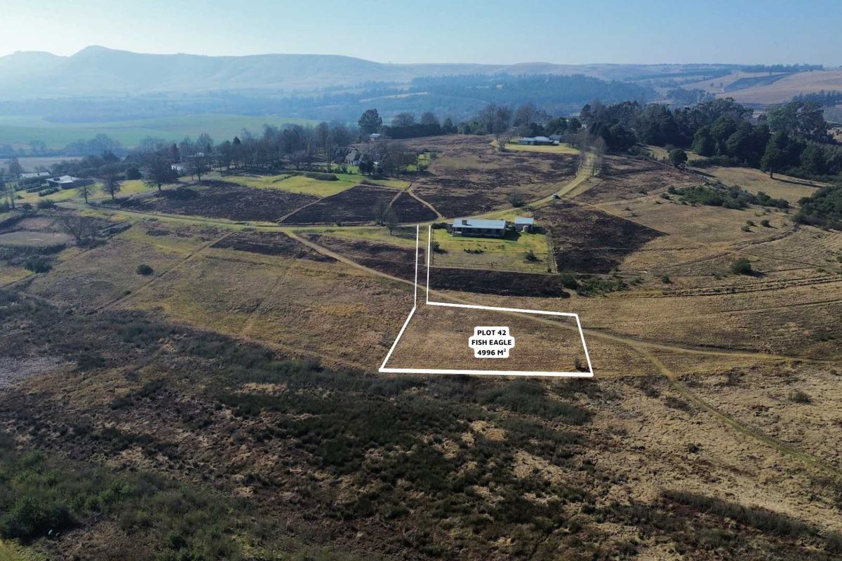 Aerial view of a 4996 square meter vacant residential plot, showcasing the surrounding landscape and defined property boundaries.