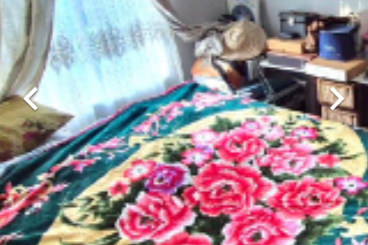 A bedroom interior featuring a window with curtains.