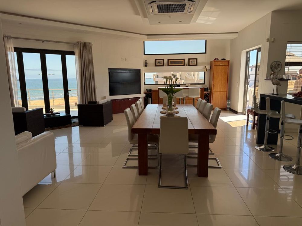 View of the open plan dining,kitchen and sunlit seating nook