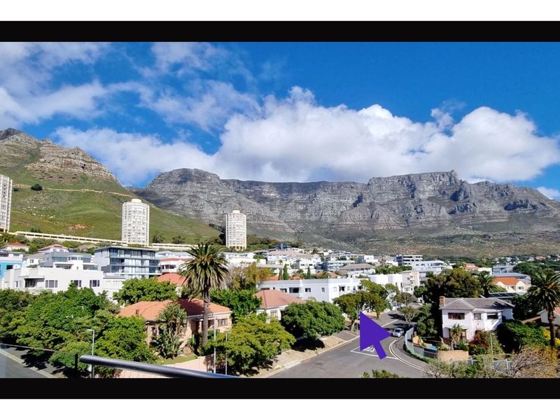 A scenic elevated view of the surrounding residential neighbourhood with the mountain range in the background.
