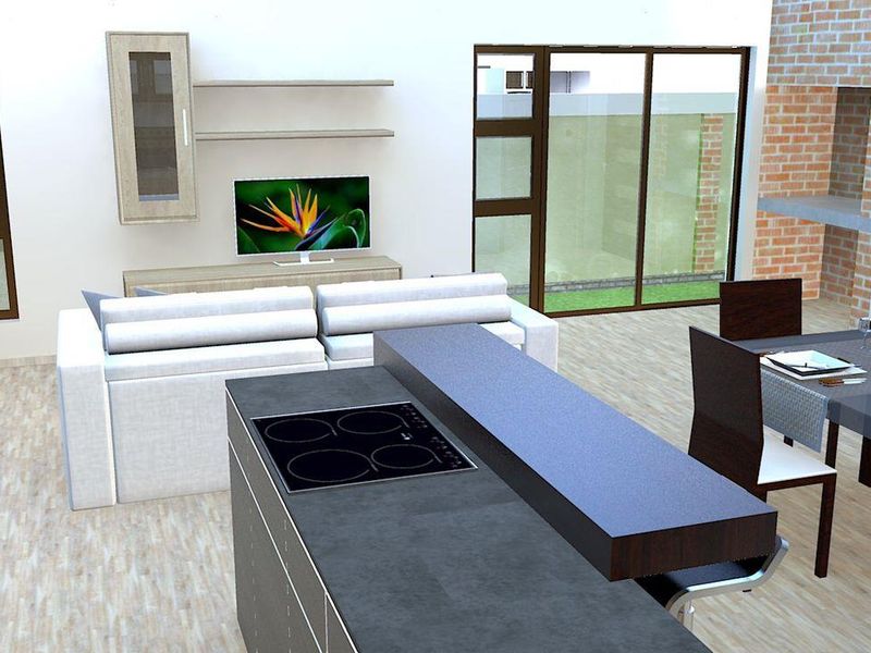 An open-plan living and kitchen area featuring a central island with a built-in induction hob, modern cabinetry, and large sliding glass doors.