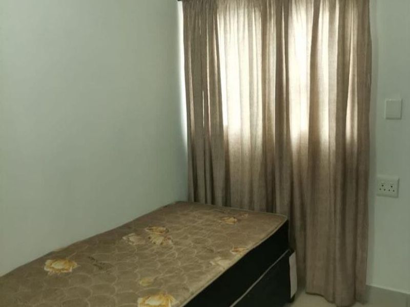 A simple bedroom featuring tiled flooring and a window with installed curtain rods.