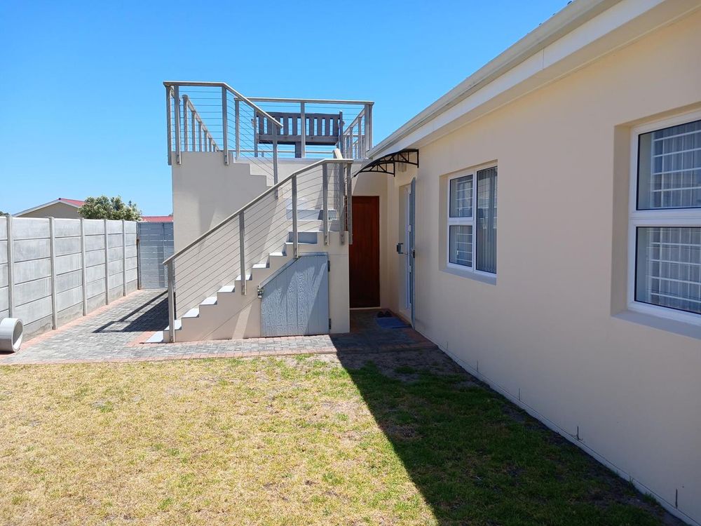 Part of Backyard - accessed via Living Area. Deck (with exceptional Sea View from Deck). Shed (below stairs) for lawnmower and gardening tools.