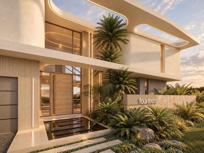 Modern architectural front facade featuring stone cladding, integrated lighting, a water feature, and a grand pivot entrance door.