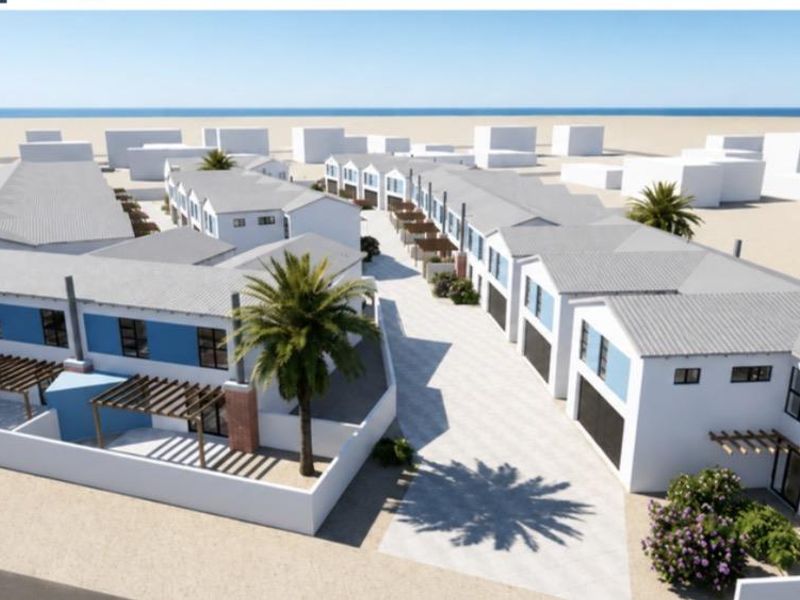 An aerial perspective of a modern townhouse development featuring multiple units with pitched roofs, paved driveways, and private outdoor pergola areas.
