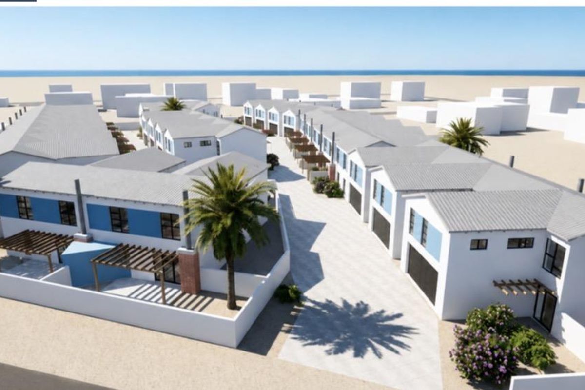 An aerial perspective of a modern townhouse development featuring multiple units with pitched roofs, paved driveways, and private outdoor pergola areas.