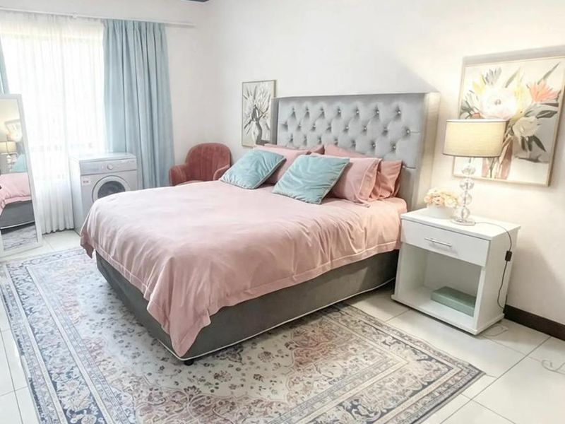 A well-maintained bedroom featuring tiled flooring and neutral wall finishes, providing a clean and functional living space.