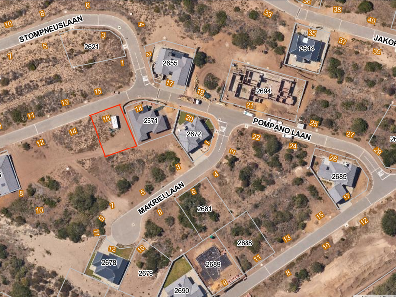 Aerial view of a vacant residential plot located in a developed estate, highlighting its position relative to surrounding properties and street access.