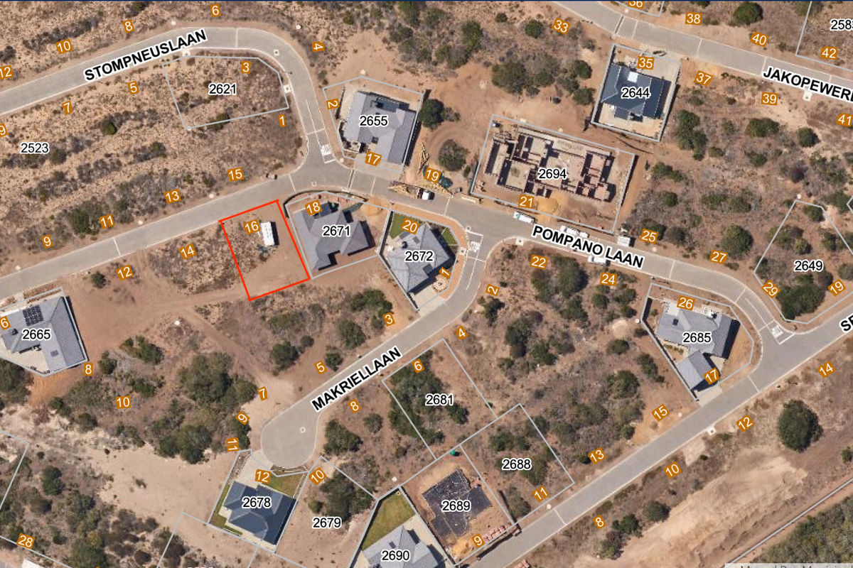 Aerial view of a vacant residential plot located in a developed estate, highlighting its position relative to surrounding properties and street access.