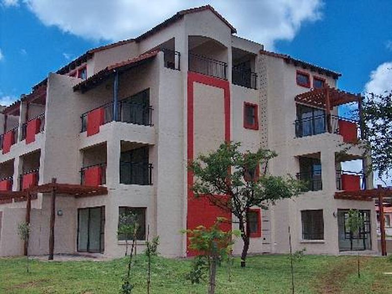 A multi-story townhouse complex featuring private balconies, timber pergolas, and sliding glass doors set against a landscaped garden area.