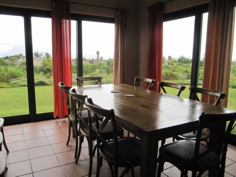 Dining area featuring large sliding glass doors that provide ample natural light and direct access to the garden.