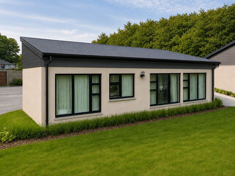 A modern single-story dwelling featuring a sleek skillion roof, clean rendered facade, and large black-framed windows overlooking a well-maintained lawn.