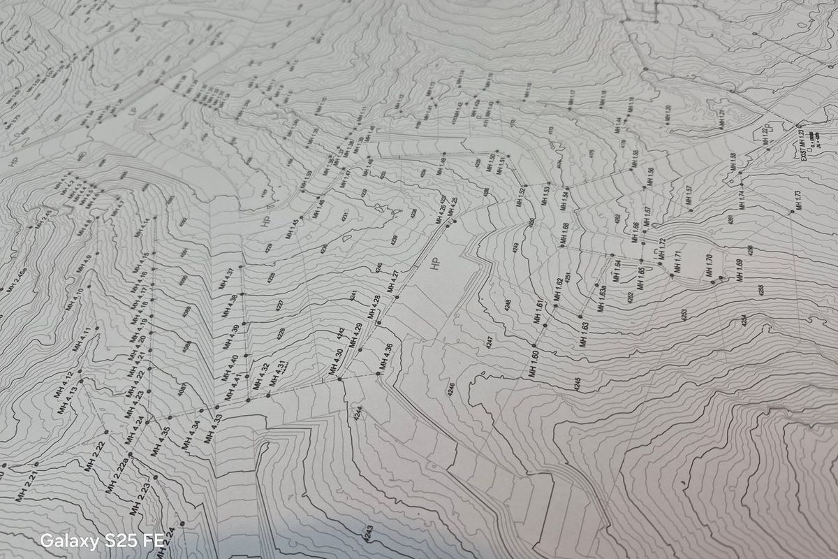 A detailed topographical survey map showing land contours, elevation markers, and infrastructure points for the residential vacant land.