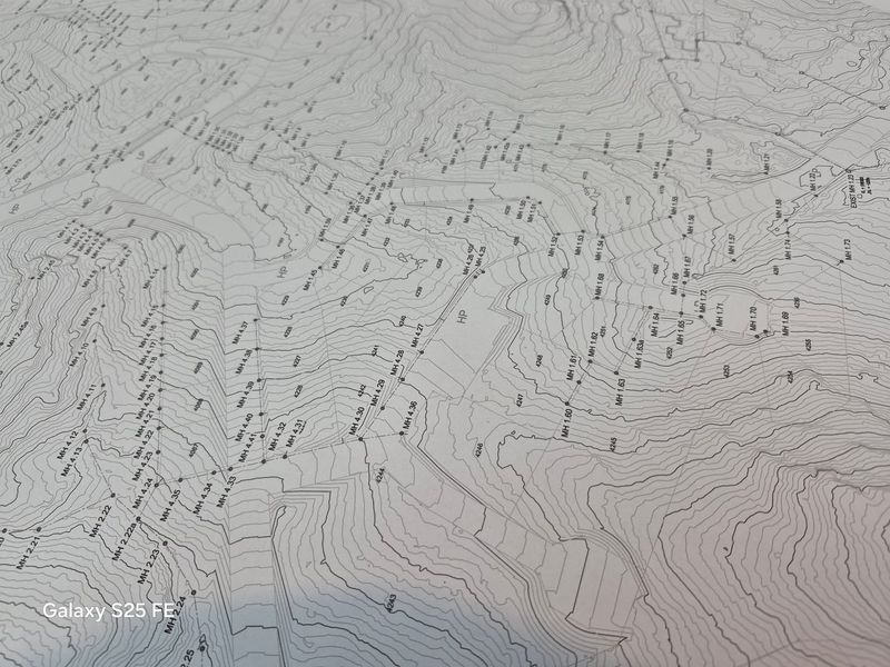 A detailed topographical survey map showing land contours, elevation markers, and infrastructure points for the residential vacant land.