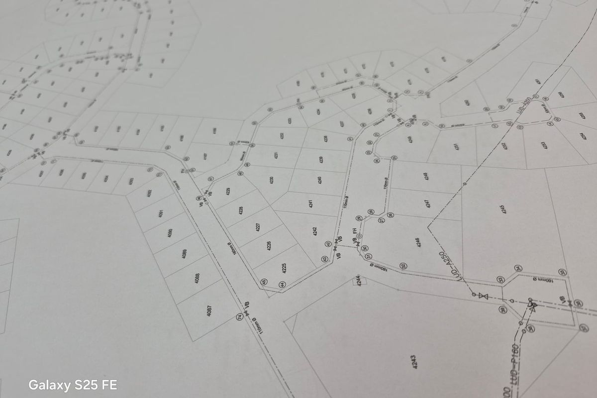 A detailed site layout plan showing residential plot boundaries and infrastructure connections for the development.