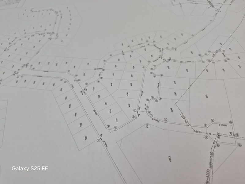A detailed site layout plan showing residential plot boundaries and infrastructure connections for the development.