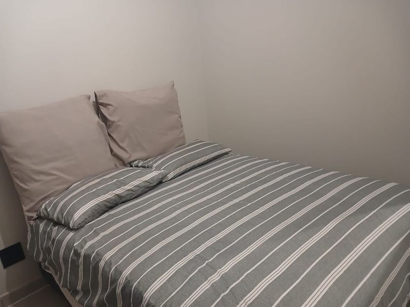 A simple bedroom space with neutral wall finishes.