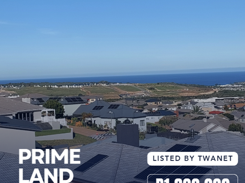 A scenic elevated view overlooking the surrounding residential estate and distant coastline, showcasing the landscape potential of the vacant land.