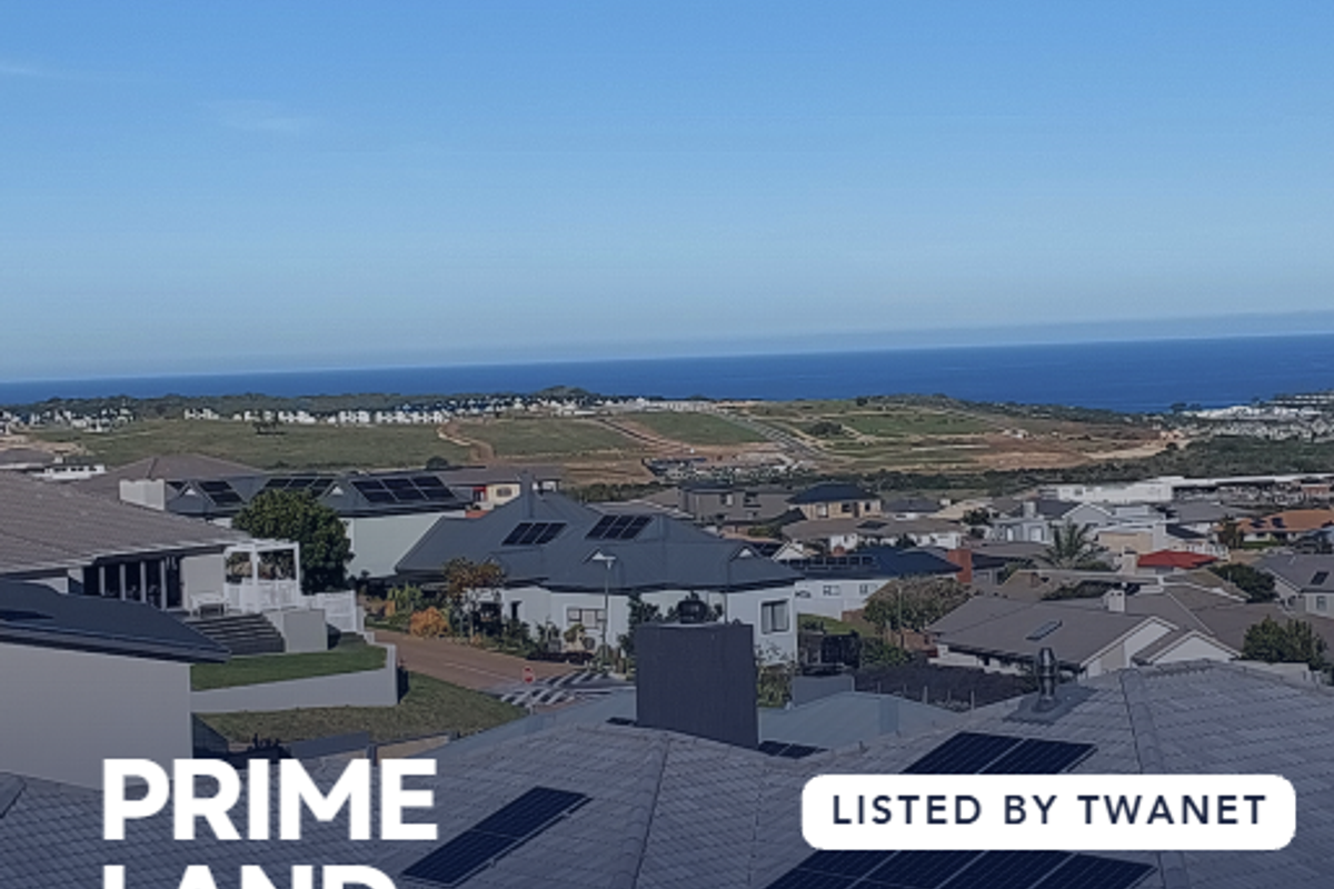 A scenic elevated view overlooking the surrounding residential estate and distant coastline, showcasing the landscape potential of the vacant land.