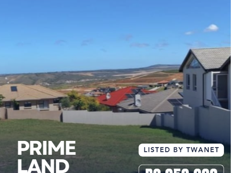 A vacant residential plot offering scenic landscape views, situated in a developed estate with established boundary walls.