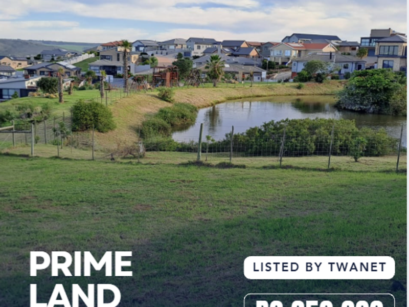 A scenic view of a vacant residential plot overlooking a pond and surrounding estate housing in Monte Christo, Western Cape.