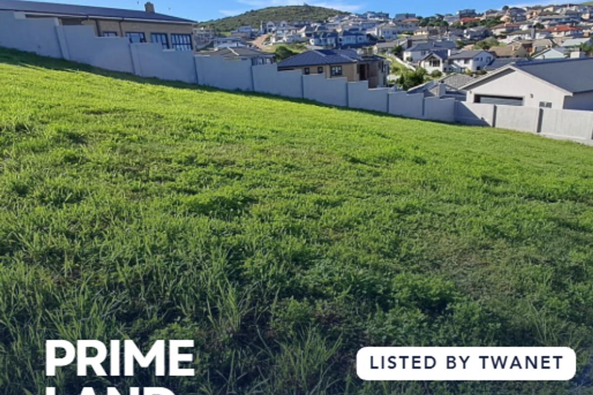 A vacant residential plot of land featuring a gentle slope and established boundary walling in a developed neighborhood.